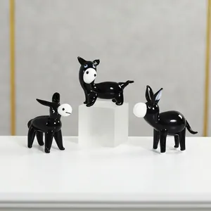 Detailed view of handcrafted black glass donkey figurines with glossy finish and cute design