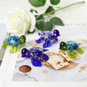 Macro view of colorful miniature glass turtle figurines on a decorative table setting