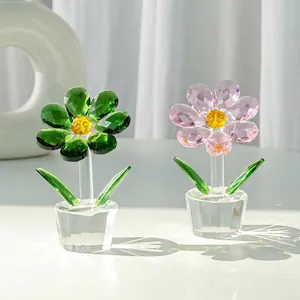 Macro detail of elegant green and pink crystal sunflower figurines reflecting sunlight
