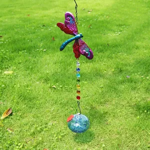 Close-up of a colorful dragonfly suncatcher with sparkling rainbow crystals for garden