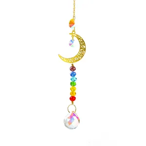 Nahaufnahme eines Regenbogen-Kristall-Sonnenfängers mit goldenem Mond und Prismenkugel