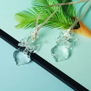 Close-up detail showing the faceted crystal angel pendant with a white and gold woven cord