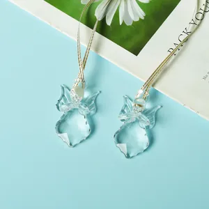 Detailed macro shot of clear crystal angel hanging ornaments for Christmas tree decoration.