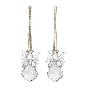Macro view of transparent crystal angel ornaments with golden hanging strings for decor.