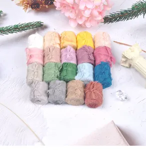 Variety of frayed edge silk ribbon rolls in multiple pastel and earth tones for DIY crafts