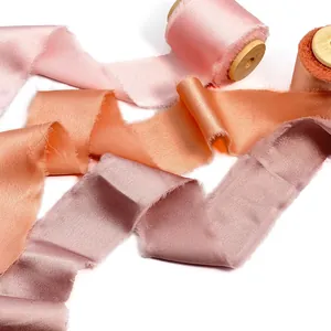 Elegant handmade frayed edge silk-like chiffon ribbon rolls in pink and peach tones