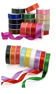 Close-up of vibrant satin ribbon rolls in various colors for creative gift wrapping