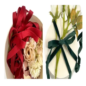 Close-up detail of red and dark green velvet ribbons for gift wrapping and decoration.