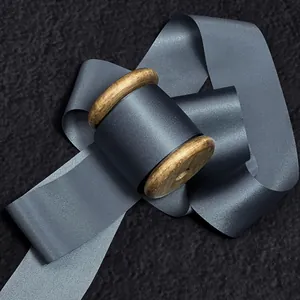 Premium 100% silk edge-cut ribbon in slate gray on vintage wooden spool