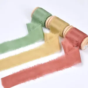 Premium frayed edge silk ribbons on wooden spools for DIY wedding crafts and gift wrapping