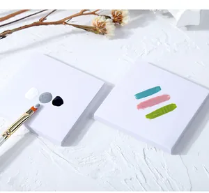 Close-up of disposable square nail mixing paper with colorful gel polish smears
