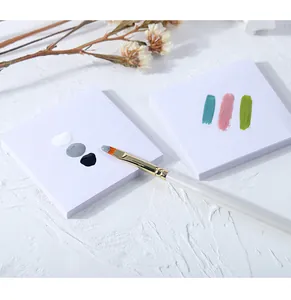 Close-up view of disposable waterproof nail mixing paper with color gel and brush