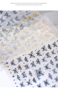 Close-up detail of 5D holographic relief butterfly nail stickers in gold, silver, and black.