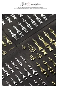 Macro detail of 3D gold and silver flame and bone nail art stickers with metallic texture