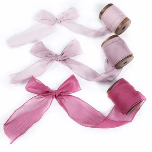 Set of three gradient pink chiffon silk ribbons tied in elegant bows for DIY crafts