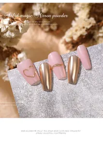 Detailed close-up showing solid gold chrome mirror nail powder and pink heart nail art