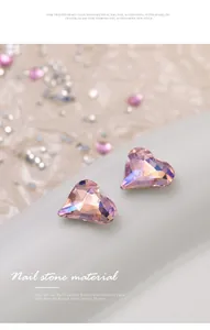 Close-up of pink heart-shaped K9 crystal rhinestones for professional nail art designs.