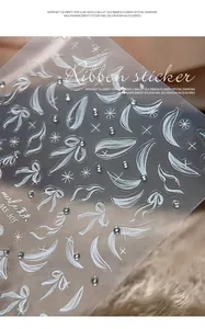 Detailed macro view of 3D ribbon relief nail art stickers with small sparkling crystals