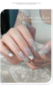 Detailed view of 3D white ribbon nail stickers with delicate rhinestone accents.