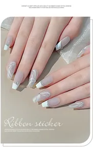 Close-up of 3D embossed nail stickers with white ribbon and crystal diamond detail