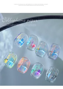 Close-up view of colorful laser cellophane fragments for irregular nail art decoration.