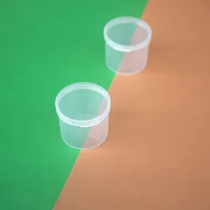 Detailed top-down view of two clear round PP plastic storage jars with hinged lids