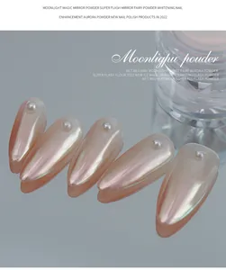 Macro detail of pearlescent moonlight white aurora powder on almond nails with pearl accents