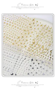Detailed macro view of gold and silver 3D star and moon nail art adhesive stickers