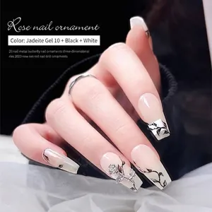 3D metal rose nail art charms on elegant jade and black floral manicured nails