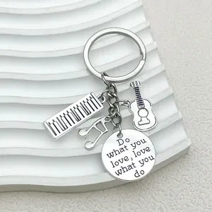 Music themed keychain with silver guitar, piano, musical note and inspirational tag