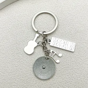 Silver music keychain detail featuring guitar note and textured metal charm elements