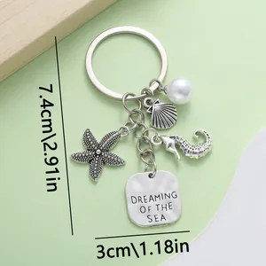 Detailed view of antique silver ocean keychain with starfish, seahorse and size specs
