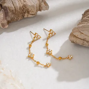 Macro view of French vintage 18K gold plated tassel earrings with zircon stones