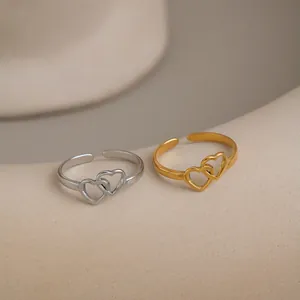 Detail of minimalist double heart cutout open rings in gold and silver stainless steel
