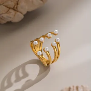 Detailed macro view of multi-layered 18K gold plated stainless steel open ring with white pearls