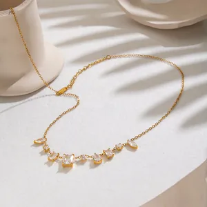 Detailed macro shot of geometric white zircon pendants on elegant gold necklace chain