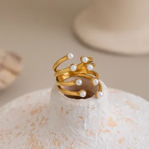 Close-up of 18K gold-plated multi-layer stainless steel ring featuring elegant white pearls.