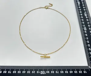 18K gold plated T-bar necklace with zircon pendant shown with measurement rulers