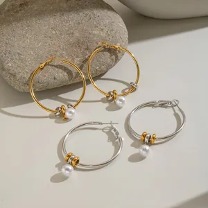 Detail view of minimalist stainless steel hoop earrings with elegant pearl charms