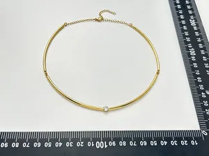 Top view of a gold plated stainless steel choker with a central CZ stone and rulers for scale