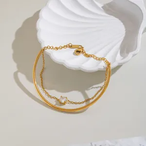 Close-up detail of 18K gold plated stainless steel bracelet with round zirconia