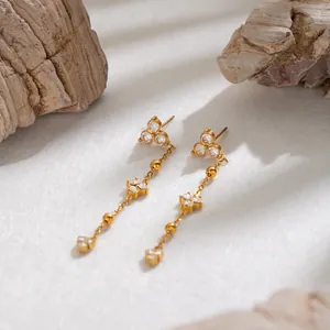 Detailed macro view of French vintage CZ tassel earrings in 18K gold plated steel