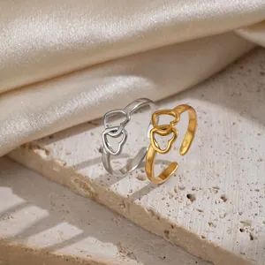 Detail showing minimalist 18K gold plated and silver stainless steel double heart open rings