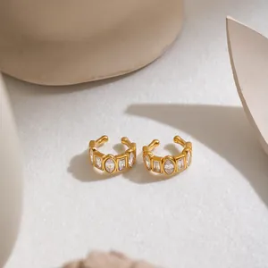 Close-up of gold-plated stainless steel ear cuffs with geometric cubic zirconia