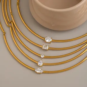 Detail of five gold plated stainless steel chokers with various zircon stone shapes