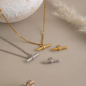 Detailed shot of T-bar pendant with inlaid zircons on gold and silver stainless necklaces