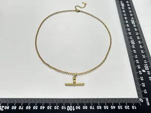 Detailed measurement view of a minimalist gold stainless steel T-bar pendant necklace.