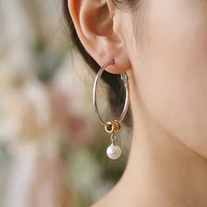 Elegant stainless steel hoop earrings with white pearl pendant and gold rings for women