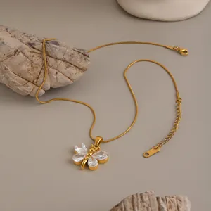 Macro detail of 18K gold plated butterfly pendant with sparkling cubic zirconia
