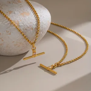 Close-up of T-shaped zircon pendant on 18K gold plated stainless steel chain necklace